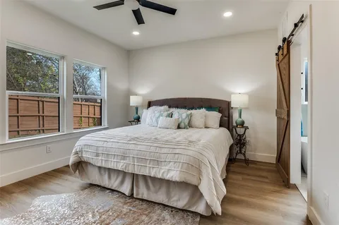 a bedroom with a large bed and a large window