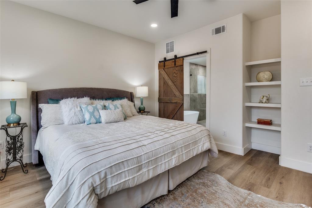 1409 Doyle Avenue Dallas, TX 75203 - Photo 27 of 40 a bedroom with a bed and a walk in closet