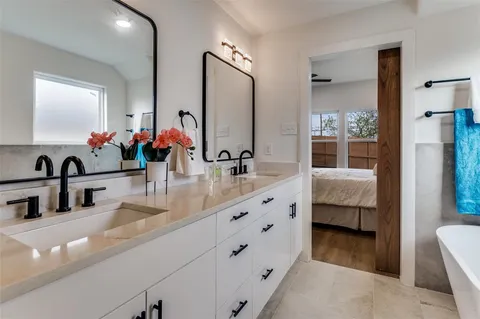 a bathroom with double vanity sinks and a mirror