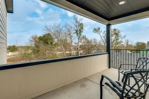 a view of a balcony with chairs