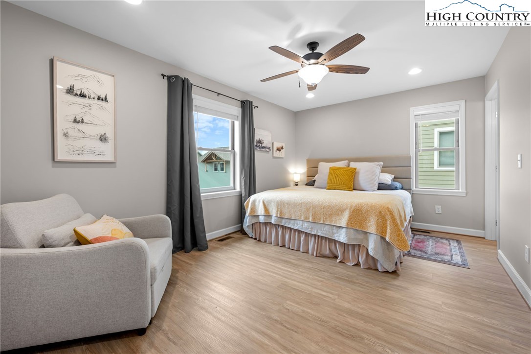 196 Miller Mdw Lane, Unit 38 Boone, NC 28607 - Photo 13 of 32 a bedroom with a bed and wooden floor