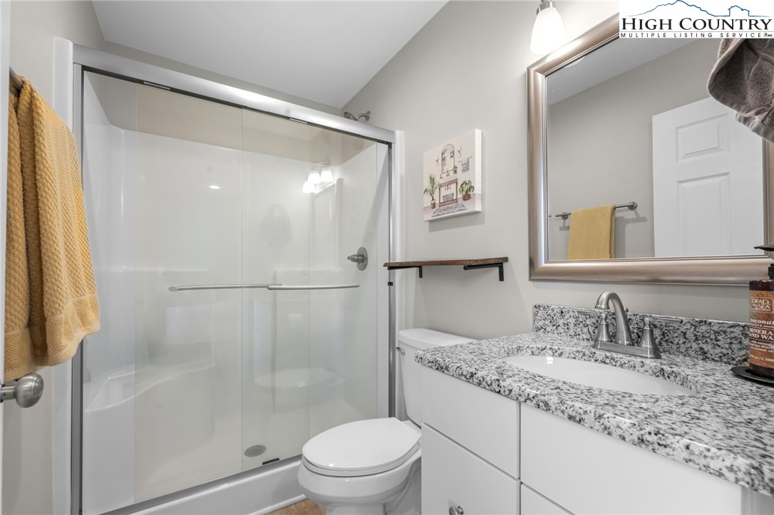 196 Miller Mdw Lane, Unit 38 Boone, NC 28607 - Photo 15 of 32 a bathroom with a granite countertop sink toilet and shower