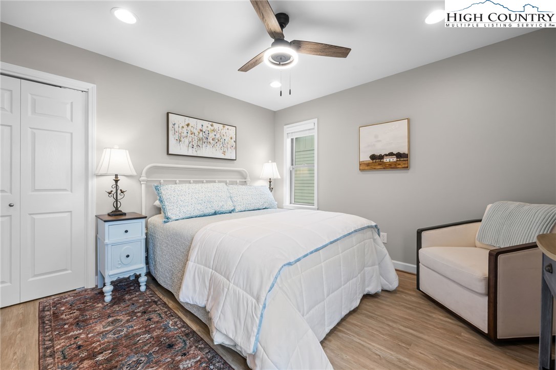 196 Miller Mdw Lane, Unit 38 Boone, NC 28607 - Photo 17 of 32 a bedroom with a bed and a chandelier