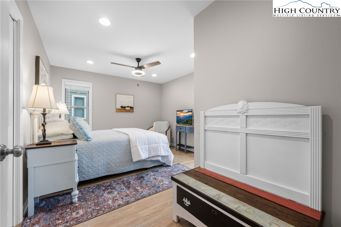 196 Miller Mdw Lane, Unit 38 Boone, NC 28607 - Photo 18 of 32 a bedroom with a bed and wooden floor
