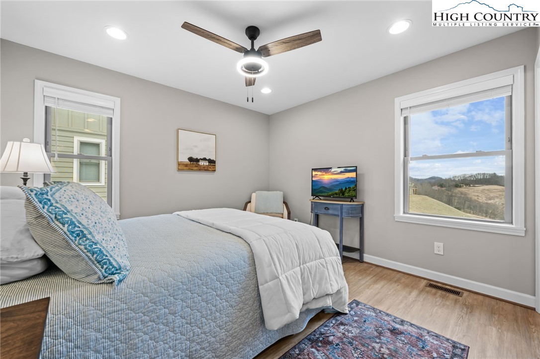 196 Miller Mdw Lane, Unit 38 Boone, NC 28607 - Photo 19 of 32 a bedroom with a bed a couch and a window