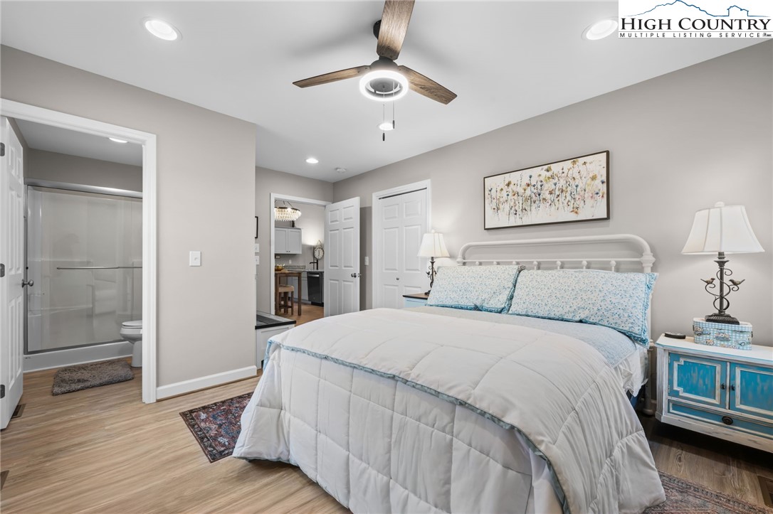 196 Miller Mdw Lane, Unit 38 Boone, NC 28607 - Photo 20 of 32 a spacious bedroom with a bed and a chandelier