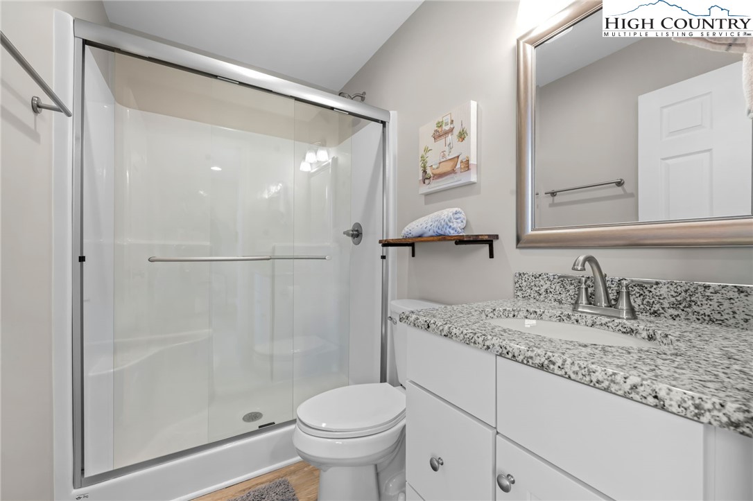 196 Miller Mdw Lane, Unit 38 Boone, NC 28607 - Photo 21 of 32 a bathroom with a granite countertop sink toilet and shower