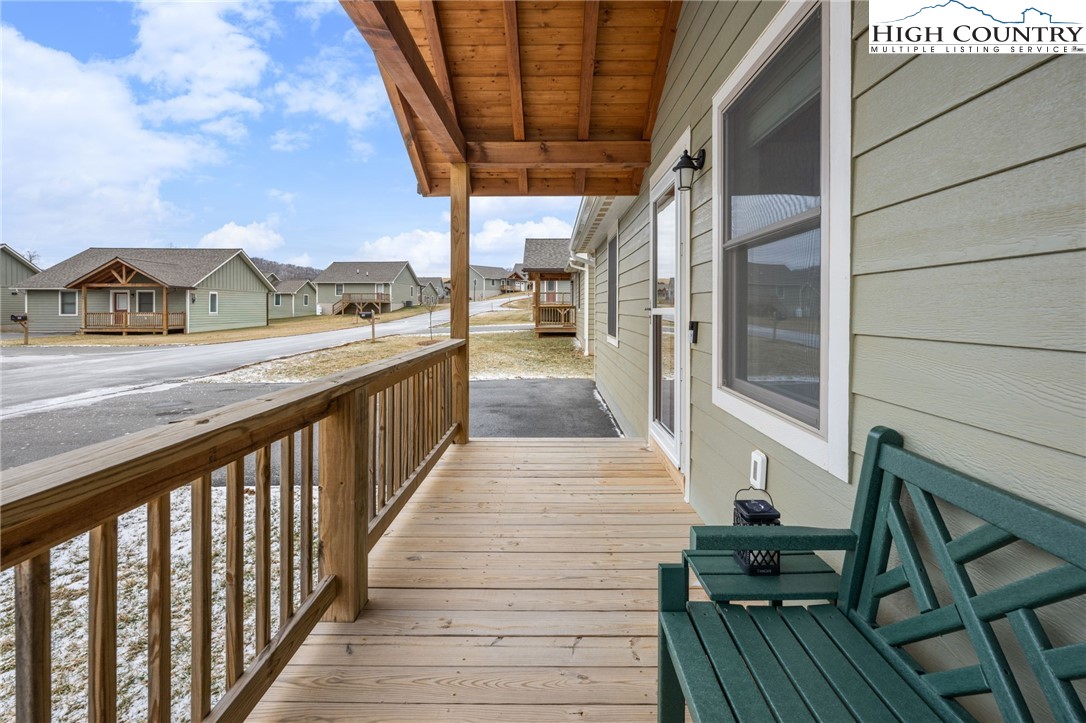 196 Miller Mdw Lane, Unit 38 Boone, NC 28607 - Photo 24 of 32 a view of a balcony with wooden floor and iron stairs