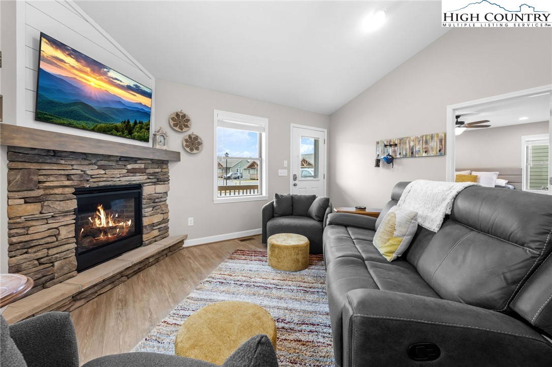 196 Miller Mdw Lane, Unit 38 Boone, NC 28607 - Photo 3 of 32 a living room with furniture a flat screen tv and a fireplace