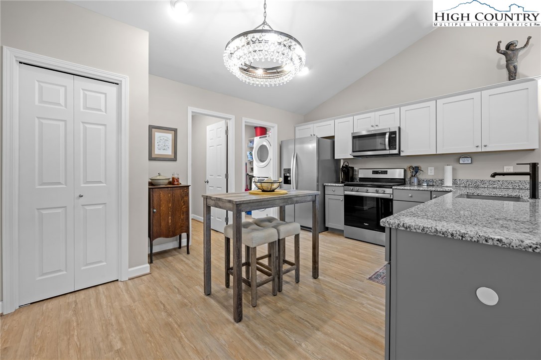 196 Miller Mdw Lane, Unit 38 Boone, NC 28607 - Photo 5 of 32 a kitchen with granite countertop cabinets stainless steel appliances and a dining table