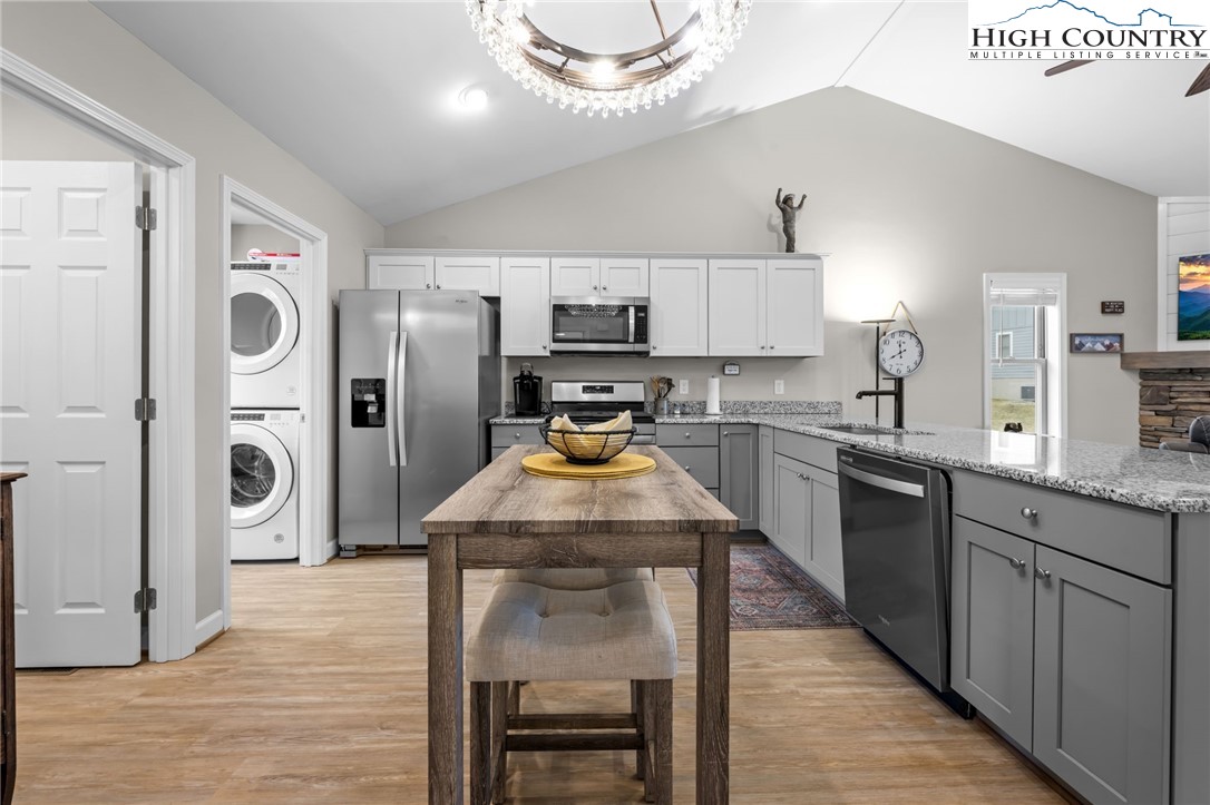 196 Miller Mdw Lane, Unit 38 Boone, NC 28607 - Photo 6 of 32 a kitchen with stainless steel appliances granite countertop a sink stove and refrigerator