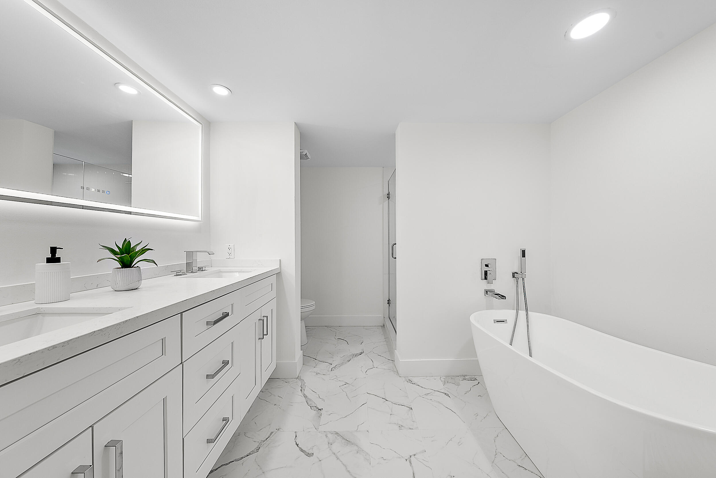 Undisclosed Address Jupiter, FL 33477 - Photo 13 of 28 a bathroom with a bathtub sink and toilet