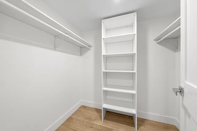 a view of walk in closet with empty racks