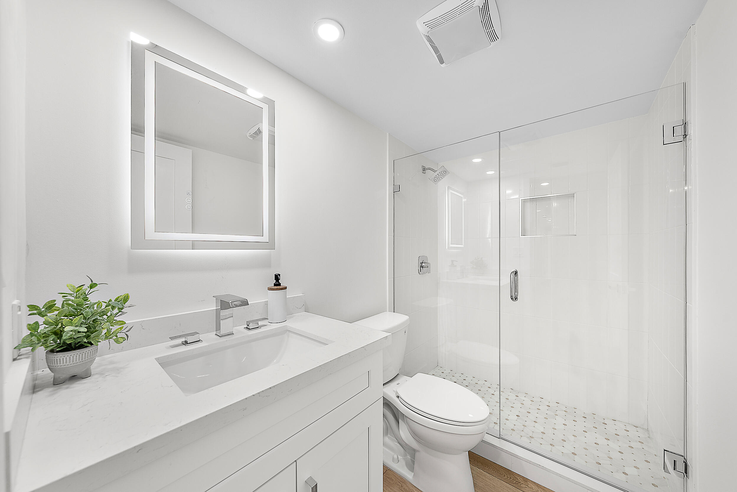 Undisclosed Address Jupiter, FL 33477 - Photo 17 of 28 a bathroom with a sink toilet a mirror and shower