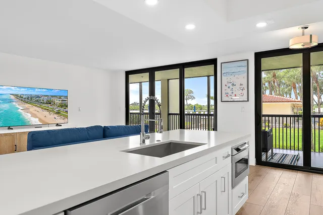a kitchen with a large window and a sink