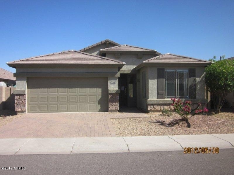 10213 West Payson Road Tolleson, AZ 85353 - Photo 1 of 24 a front view of a house with a garden and porch