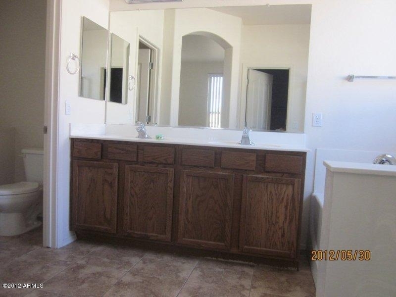 10213 West Payson Road Tolleson, AZ 85353 - Photo 12 of 24 a bathroom with a double vanity sink and a mirror