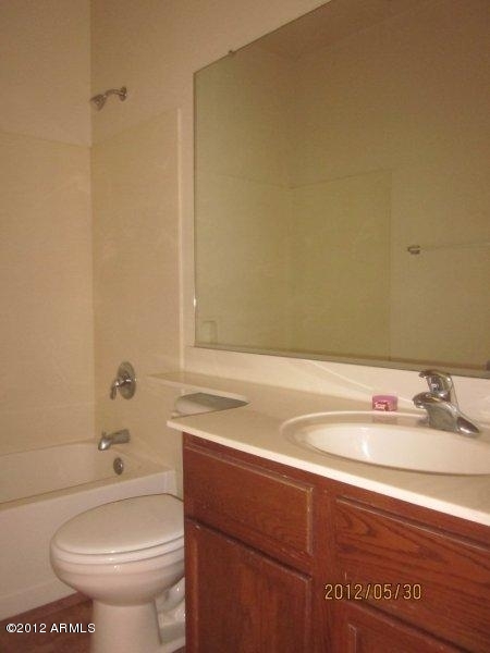 10213 West Payson Road Tolleson, AZ 85353 - Photo 16 of 24 a bathroom with a sink and a toilet