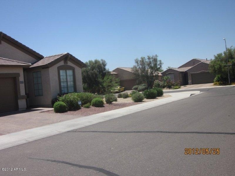 10213 West Payson Road Tolleson, AZ 85353 - Photo 2 of 24 a front view of a house with a yard and garage