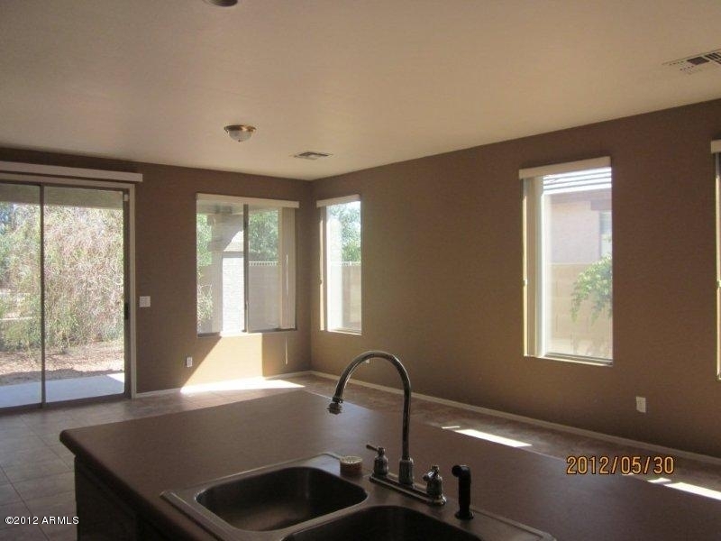 10213 West Payson Road Tolleson, AZ 85353 - Photo 6 of 24 a view of a room that has a bed and a window