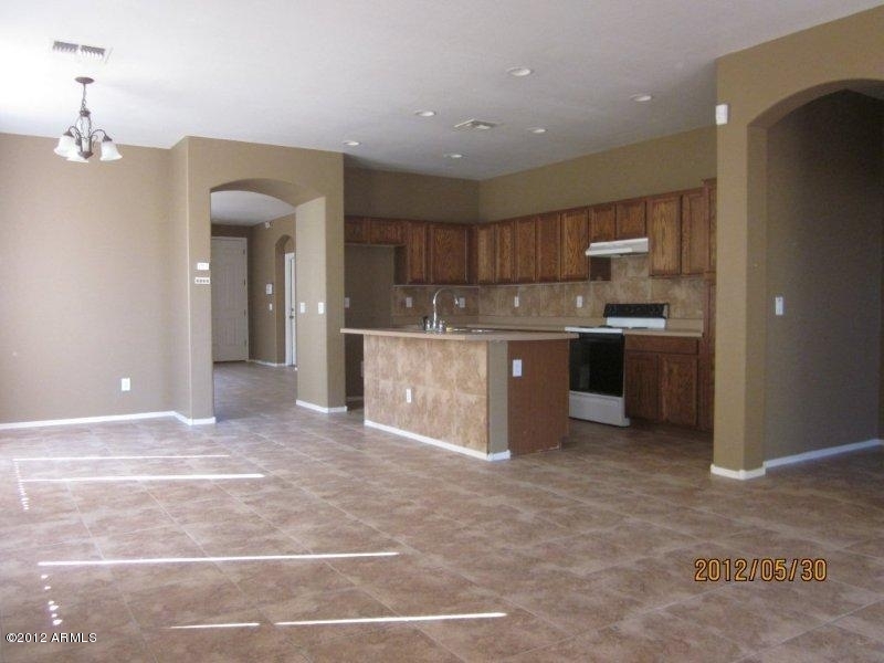 10213 West Payson Road Tolleson, AZ 85353 - Photo 7 of 24 a view of kitchen with kitchen island microwave and cabinets