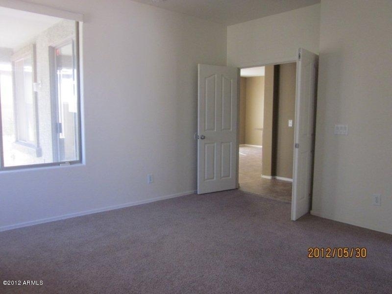 10213 West Payson Road Tolleson, AZ 85353 - Photo 8 of 24 an empty room that has a window in it