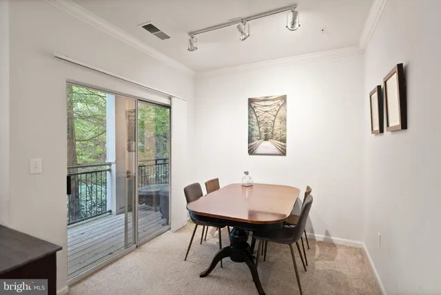 a view of a dining room with furniture and window