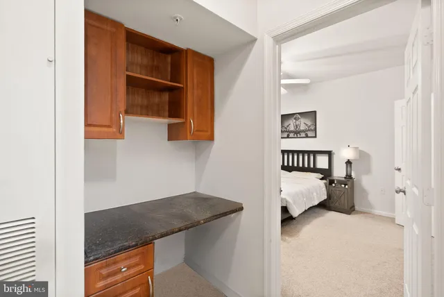 a en suite bathroom with a granite countertop sink and a mirror