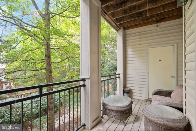 a living room with a large window and furniture