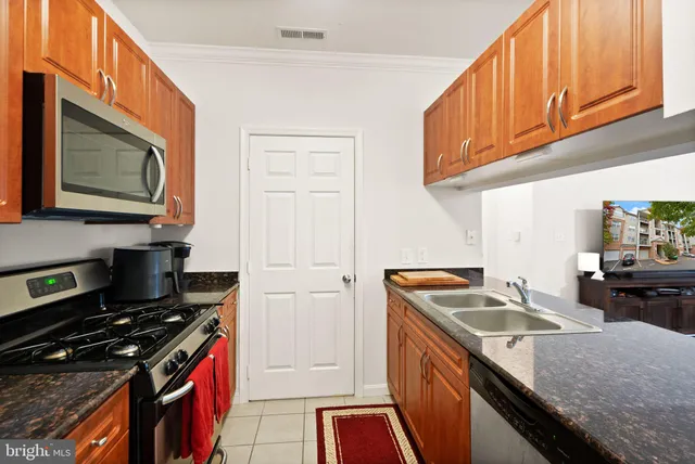 a kitchen that has a sink and a stove