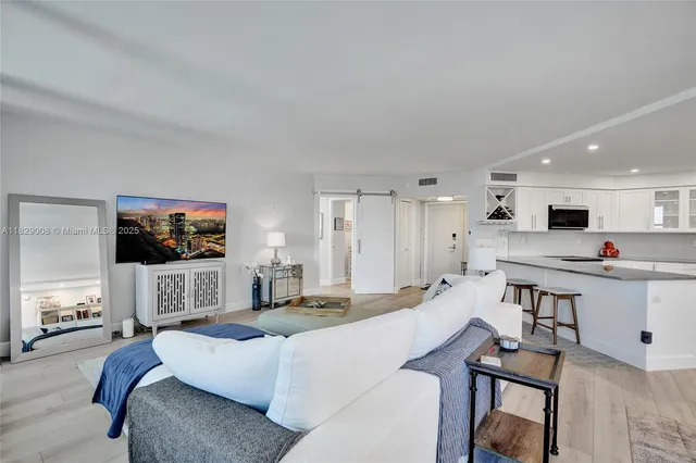 a bedroom with a bed and a tv on dresser