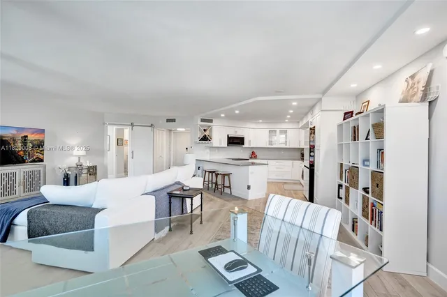 a bedroom with a bed a couch and a flat screen tv