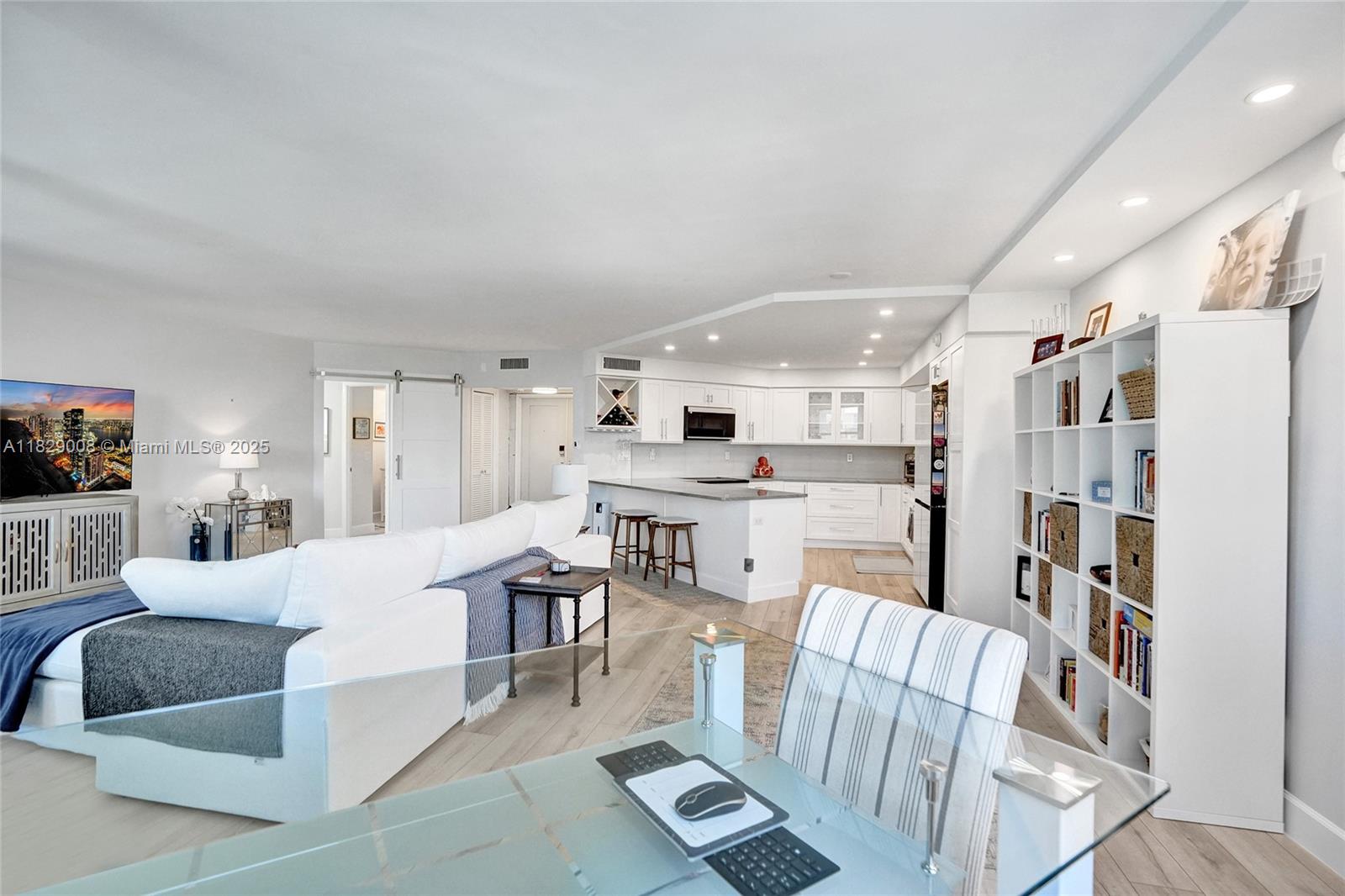 1340 South Ocean Boulevard, Unit 403 Pompano Beach, FL 33062 - Photo 13 of 74 a living room with furniture and a book shelf