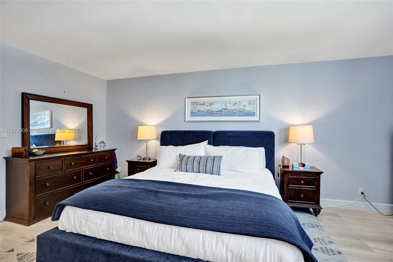 1340 South Ocean Boulevard, Unit 403 Pompano Beach, FL 33062 - Photo 16 of 74 a bedroom with a bed and a tv on dresser