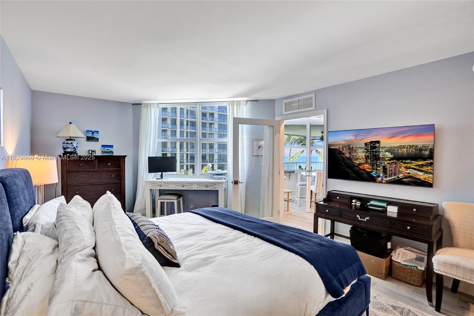 1340 South Ocean Boulevard, Unit 403 Pompano Beach, FL 33062 - Photo 22 of 74 a bedroom with a bed and a flat screen tv