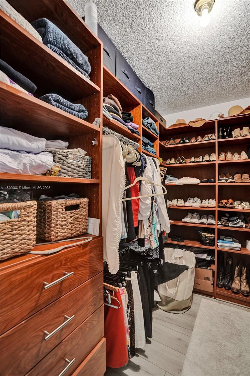 1340 South Ocean Boulevard, Unit 403 Pompano Beach, FL 33062 - Photo 27 of 74 a view of walk in closet with clothes and shoes