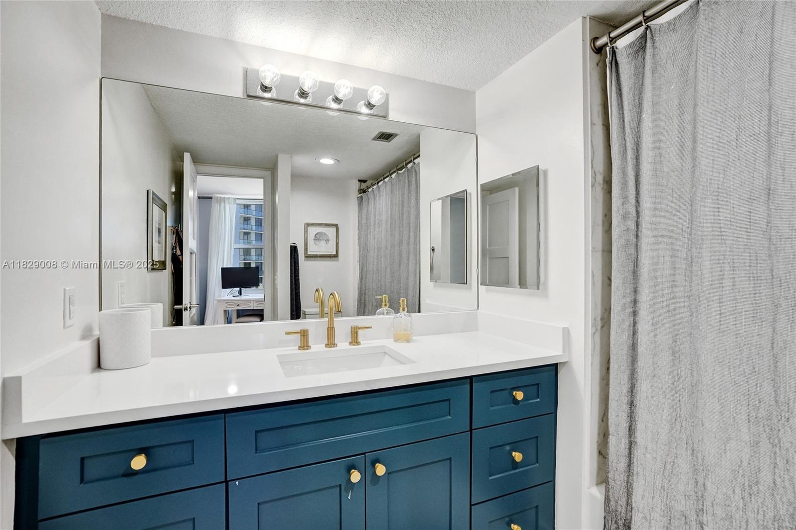 1340 South Ocean Boulevard, Unit 403 Pompano Beach, FL 33062 - Photo 28 of 74 a bathroom with a double vanity sink and a mirror