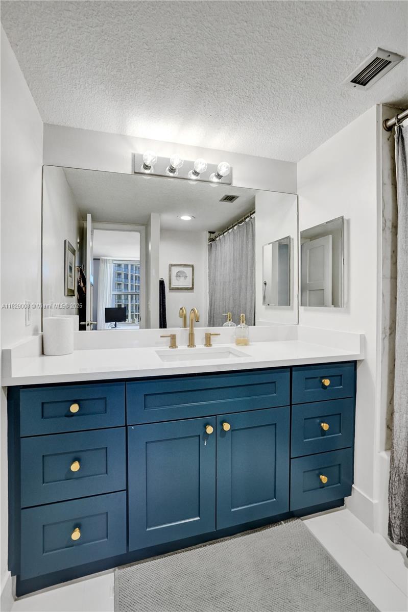 1340 South Ocean Boulevard, Unit 403 Pompano Beach, FL 33062 - Photo 29 of 74 a bathroom with a granite countertop sink vanity and mirror