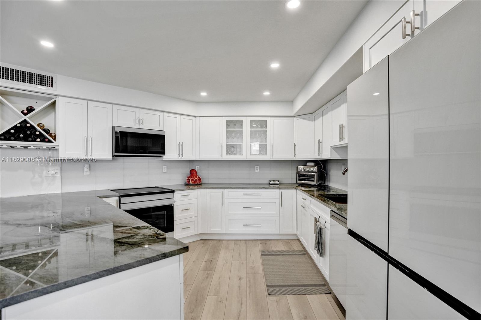 1340 South Ocean Boulevard, Unit 403 Pompano Beach, FL 33062 - Photo 31 of 74 a kitchen with stainless steel appliances granite countertop a stove and a sink