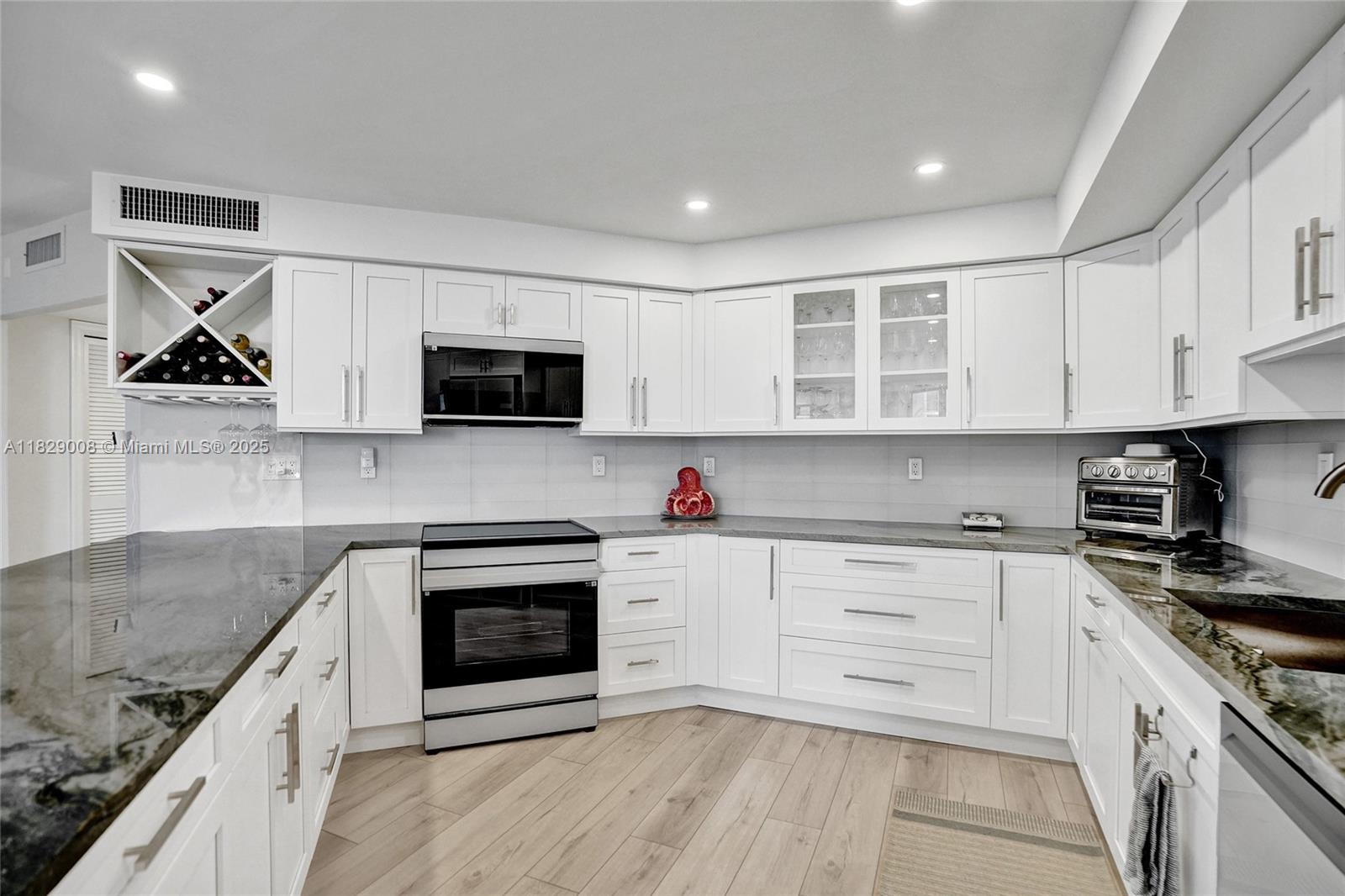 1340 South Ocean Boulevard, Unit 403 Pompano Beach, FL 33062 - Photo 33 of 74 a kitchen with stainless steel appliances granite countertop a stove and a sink