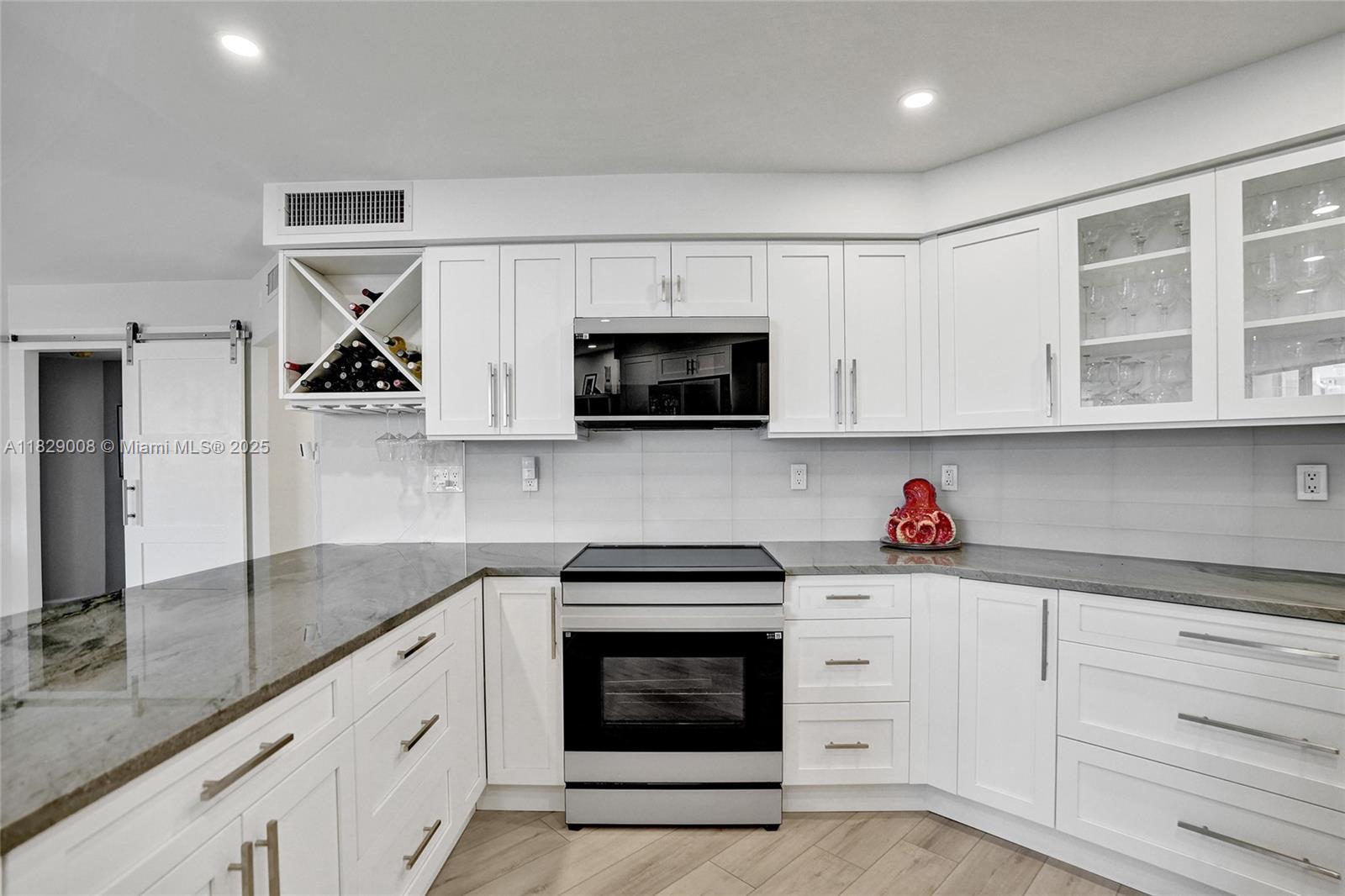 1340 South Ocean Boulevard, Unit 403 Pompano Beach, FL 33062 - Photo 34 of 74 a kitchen with white cabinets and sink