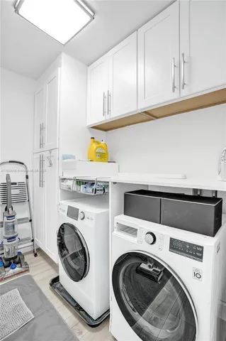a large kitchen with stainless steel appliances a refrigerator and a counter top space