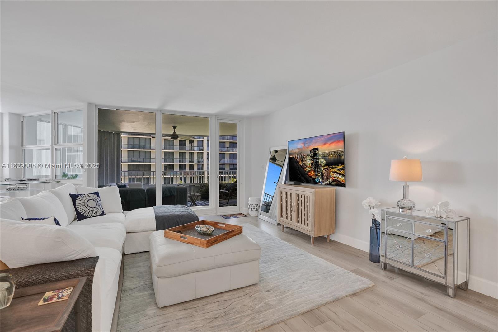 1340 South Ocean Boulevard, Unit 403 Pompano Beach, FL 33062 - Photo 5 of 74 a living room with furniture and a flat screen tv