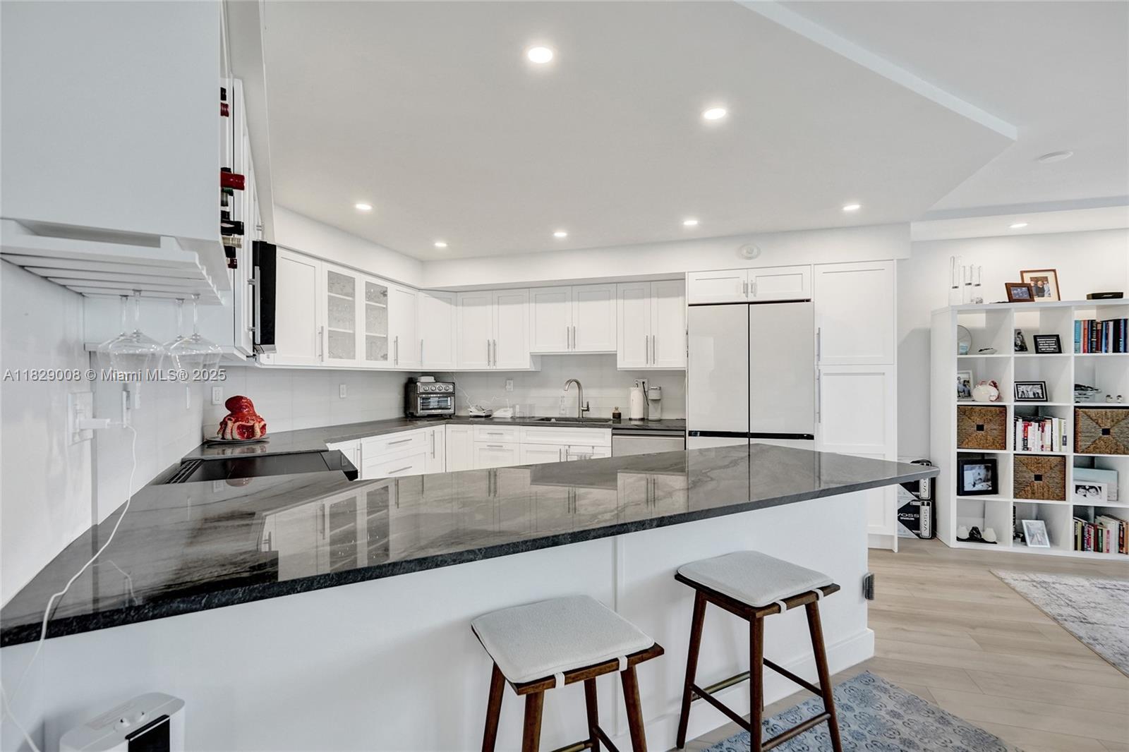 1340 South Ocean Boulevard, Unit 403 Pompano Beach, FL 33062 - Photo 8 of 74 a large kitchen with stainless steel appliances granite countertop a sink and cabinets