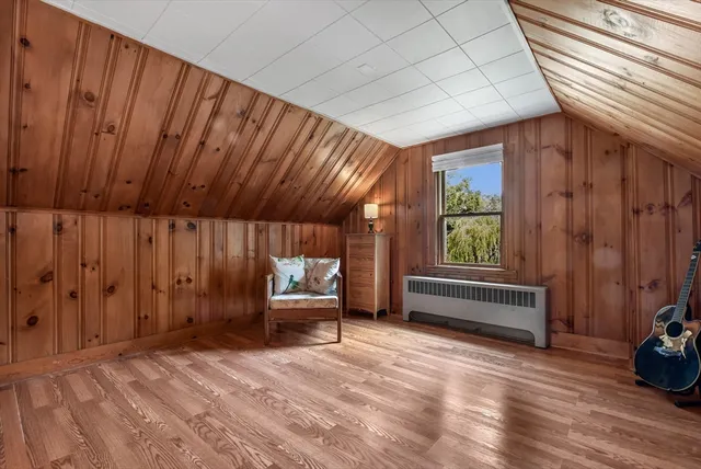 a view of a room with wooden floor and furniture