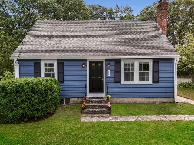 a front view of a house with a garden