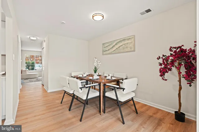 a dining room with furniture and wooden floor