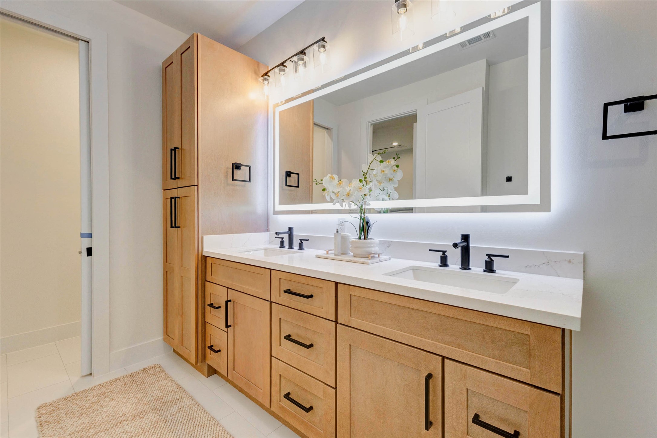 3309 St Emanuel Street Houston, TX 77004 - Photo 42 of 47 LED vanity mirrors with multicolor lighting and built-in defoggers. Space-saving pocket doors enhance functionality.