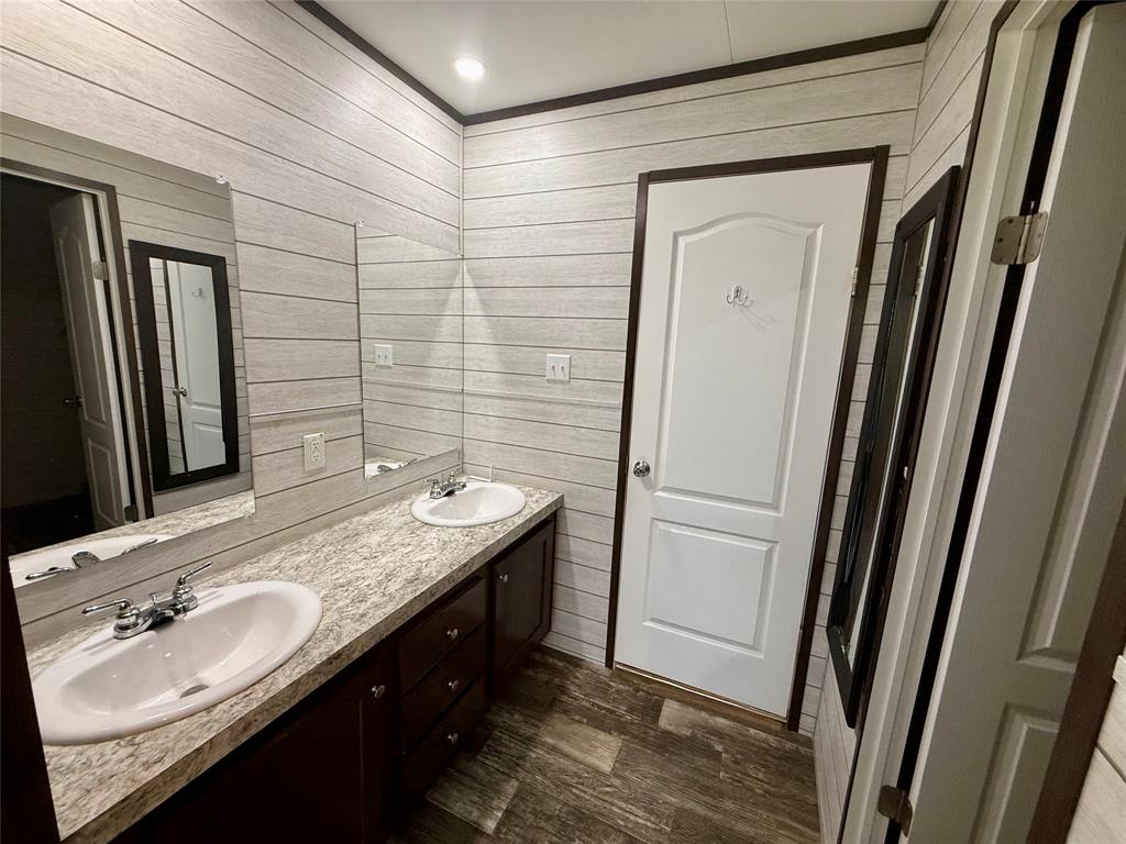 145 Adalida Lane Springtown, TX 76082 - Photo 15 of 29 Dual vanity featuring an integrated countertop, under-mount sinks, and individual mirrors