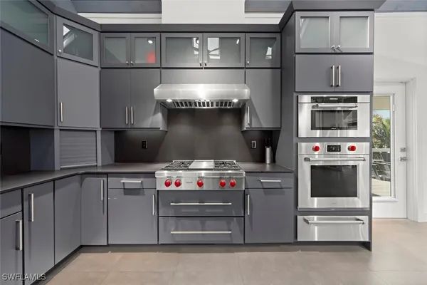 a kitchen with stainless steel appliances a stove and a microwave